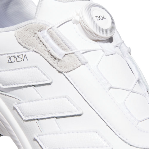 Close-up of the Adidas 2025 Zoysia Boa Spikeless Women’s Golf Shoes in Cloud White, a lightweight women’s golf shoe by Adidas featuring the BOA Fit System for easy adjustment and stylish textured white and gray accents.