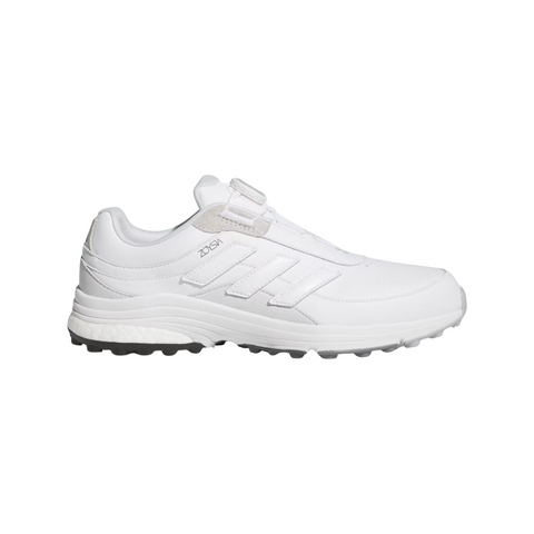 The Adidas 2025 Zoysia Boa Spikeless Women’s Golf Shoes in Cloud White feature a textured spikeless sole and iconic three stripes, shown in a side profile against a plain background.