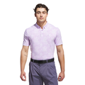 A man stands facing forward against a white background wearing an Adidas Men's Go-To Printed Polo Shirt in Powder Plum/White, paired with purple pants and a black belt.