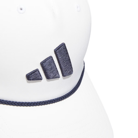 Close-up of the Adidas Mens Tour Five-Panel Hat in white, featuring a dark blue embroidered Adidas logo and matching braided trim above the brim. This stylish, breathable golf cap delivers comfort on the course.