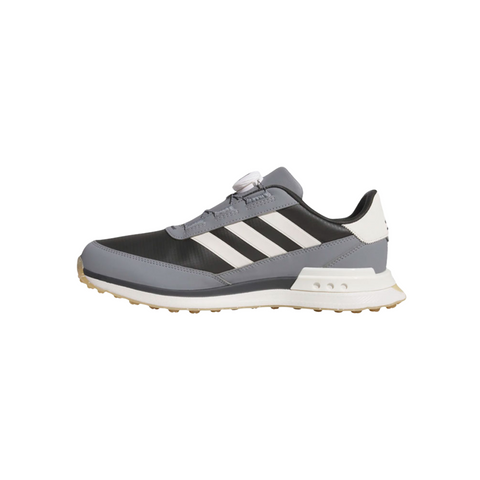 The Adidas S2G 24 BOA Men’s Golf Shoes in Carbon, Chalk White, and Grey Three feature a spikeless tan grippy sole, white stripes and heel, and the BOA Fit System for a secure fit. The brand is Adidas and the background is plain white.