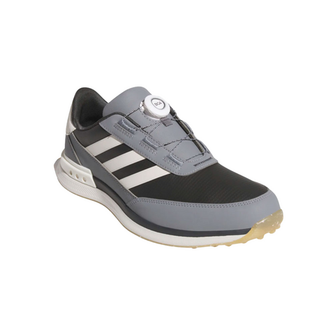 A Carbon, Chalk White, and Grey Three Adidas S2G 24 BOA Men’s Golf Shoe with white stripes and BOA Fit System on the tongue rests angled on a white background, showcasing a translucent spikeless sole.