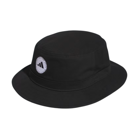The Adidas Solid Bucket Hat | Black features a wide brim and a circular white Adidas logo patch on the front, offering stylish sun protection for both golf and everyday wear.