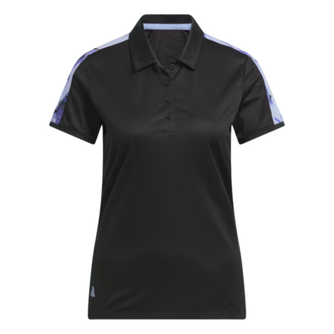 The Adidas Ultimate365 Womens Printed Polo is a black, short-sleeve golf shirt with a collar and buttons, featuring light purple patterned shoulder stripes. This moisture-wicking Adidas polo combines style and comfort for any round.