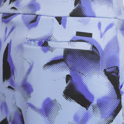 Close-up of the back pocket on the Adidas Ultimate365 Womens Skort by Adidas, showcasing its light blue, purple, and black abstract pattern with a sleek horizontal slit pocket—no button or flap—for a stylish golf look.
