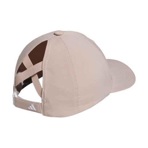 The Adidas Womens Crisscross Hat in Wonder Taupe features an open crisscross back, adjustable strap, and sun protection. The Adidas logo accents the lower left side—ideal as a women’s golf hat for sunny days.
