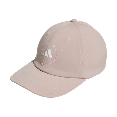 The Adidas Womens Crisscross Hat in Wonder Taupe features a curved brim, white embroidered logo, and “A Brand. Full The Brand. Classic Human” text on the front—stylish sun protection ideal for golf.
