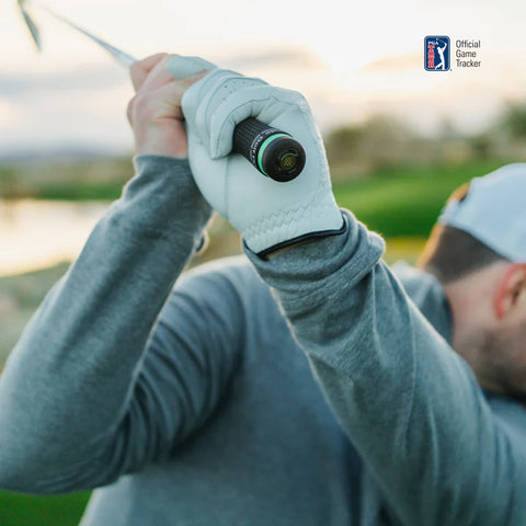 A golfer in a gray long-sleeve shirt and white glove grips the club with Arccos Smart Sensors Gen 4 Green by Arccos. In the background, the PGA Tour Official Game Tracker logo highlights automatic shot tracking features.