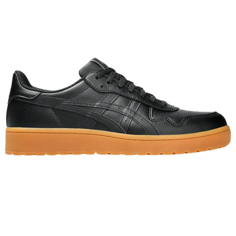The Asics Japan S Mens Golf Shoes by Asics feature black leather, black laces, and a textured gum rubber sole, displayed in side profile on a white background.