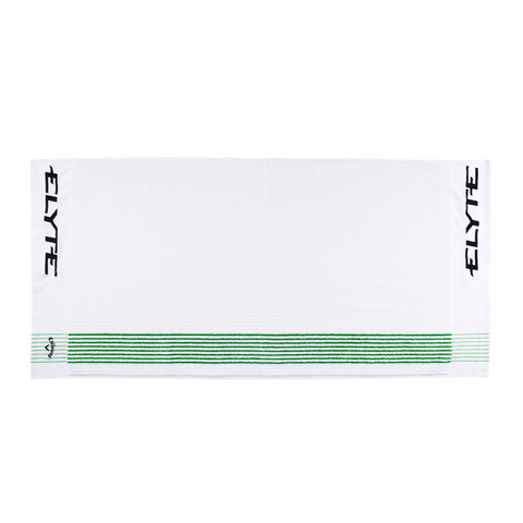 The Callaway Elyte Caddy Towel is a white golf towel with ELYTE in black on both ends and green horizontal stripes near one edge, designed by Callaway for tour-level performance.