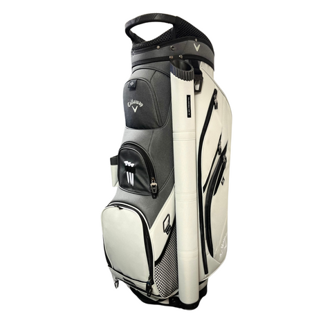 A white and gray Callaway Forrester Cart Bag 2025 by Callaway, featuring a 14-way top, multiple zippered compartments, a top handle, and a cylindrical side holder, stands upright on a white background.