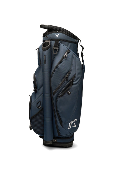 The Callaway Forrester Cart Bag 2025 by Callaway, in navy blue, features a 14-way top, several zippered pockets, and a side handle, shown standing upright against a white background.