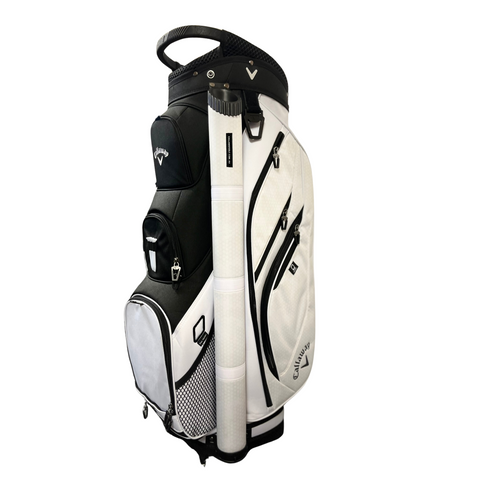 The Callaway Forrester Cart Bag 2025, in black and white, features a 14-way top, multiple zippered pockets, a top handle, and a mesh side pocket. It stands upright on a white background.