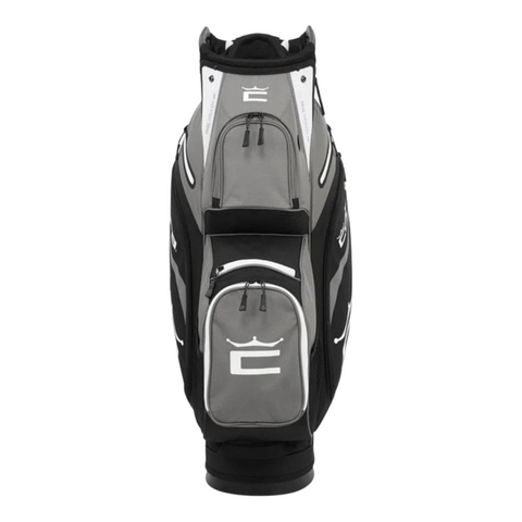 The Cobra 2025 Signature Cart Bag in Black/Grey features multiple zippered pockets and a prominent stylized crown logo on the front.