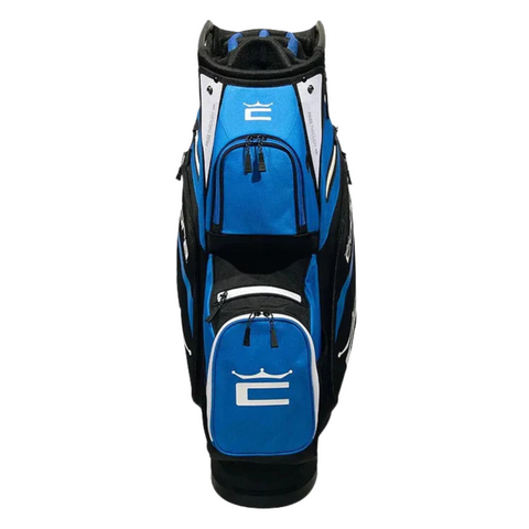 The Cobra 2025 Signature Cart Bag in Electric Blue/White/Black features a 14-way top, multiple zippered pockets, and a white crown logo on the front pocket, shown from the front against a white background.