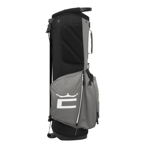 The Cobra 2025 Signature Stand Bag in Black/Grey by golf360nz features a large zippered side pocket and white Cobra logo (stylized C with crown), shown upright on a white background.
