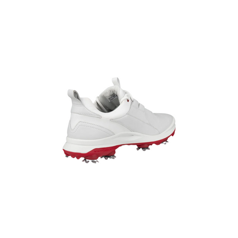 A single ECCO Biom Tour Womens Golf Shoe by Ecco, in white with a red sole and gray cleats, is shown from the back and side on a plain white background—ideal for women seeking stylish waterproof golf shoes.