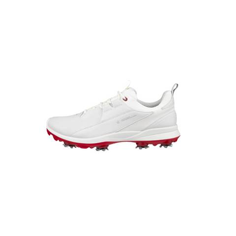 The Ecco Biom Tour Womens Golf Shoes are shown in white with a red sole and silver spikes, displayed in side profile on a plain white background, highlighting their stylish design and waterproof features.