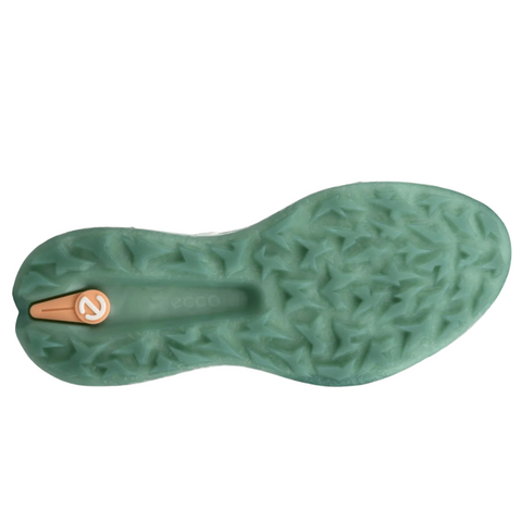 The image shows the bottom of an ECCO Womens Biom H5 Golf Shoe 2025 by Ecco, featuring a textured, translucent green sole with a star-shaped tread and a small orange circular logo near the heel.