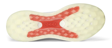 The image shows the sole of Ecco Womens LT1 Golf Shoes in white, with a red X-shaped pattern and diamond cutouts for lightweight comfort and all-round grip. The ECCO logo appears on the red area of the sole.