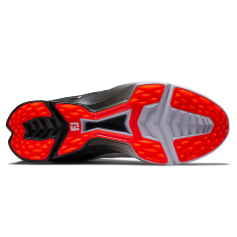 The image displays the outsole of the FootJoy 2025 Men's Fuel Golf Shoes, featuring a bold design with bright red-orange patterned grip zones, black central areas, and white rubber accents for traction on these spikeless shoes.