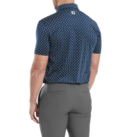 A man is seen from behind wearing the FootJoy Men's Flower Bud Foulard Lisle Polo in navy and gray pants. This short-sleeve polo features ProDry performance fabric and a small white FootJoy logo near the collar on the upper back.