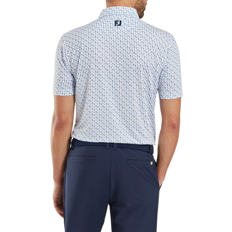 A man seen from the back wears a FootJoy Mens Pique Solid Figure Print Lisle Polo in white/navy and dark blue trousers. The moisture-wicking polo displays a small FJ logo just below the collar at the upper back.