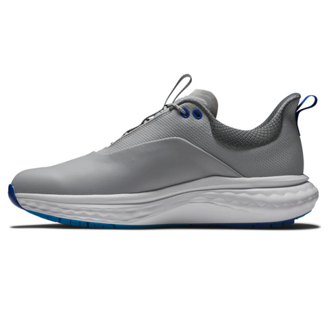 A side view of the FootJoy Quantum Mens Golf Shoes by FootJoy highlights their modern sneaker style with a light gray upper, cushioned white sole, blue accents, and spikeless design—blending comfort and style on the course.