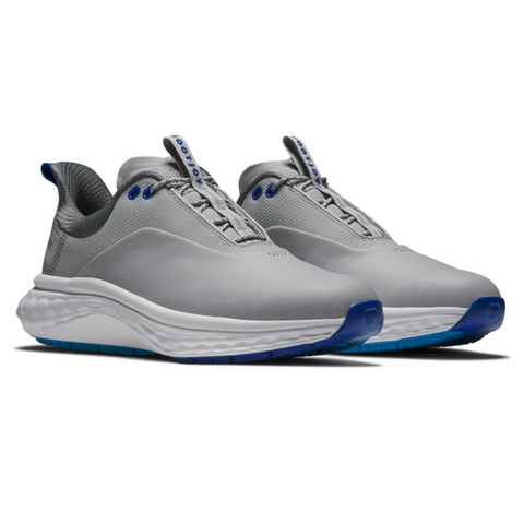 The FootJoy Quantum Mens Golf Shoes by FootJoy feature a modern gray design with blue accents, white midsoles, and textured blue outsoles. These spikeless sneakers combine style and comfort, shown angled on a white background.