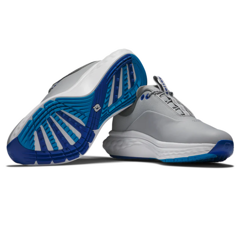 A pair of gray FootJoy Quantum Mens Golf Shoes by FootJoy features blue and white soles. One shoe stands upright while the other is tilted, showcasing the grooved spikeless tread for both style and function.