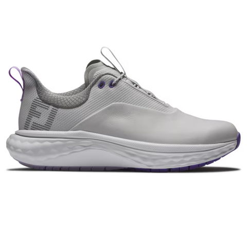 The FootJoy Quantum Womens Golf Shoes are white athletic sneakers with a thick, textured sole, purple accents on the heel tab and eyelets, a gray mesh collar, subtle logo, and lace-up spikeless design.