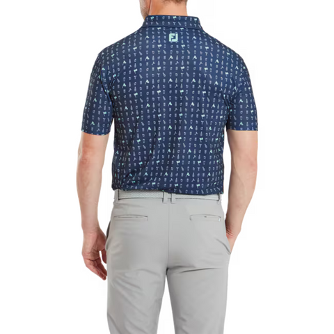 Back view of the FootJoy 19th Hole Polo worn by a model. The navy blue polo displays a golf-themed print and features the FootJoy logo on the upper back. Paired with light grey trousers, the shirt highlights its relaxed fit and modern style.