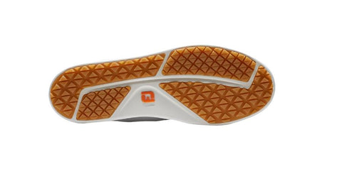 The image displays the sole of the FootJoy Women's Links Golf Shoes in white. The mostly white sole has orange-brown sections with a triangular tread pattern and a small orange and white FootJoy logo at the center.