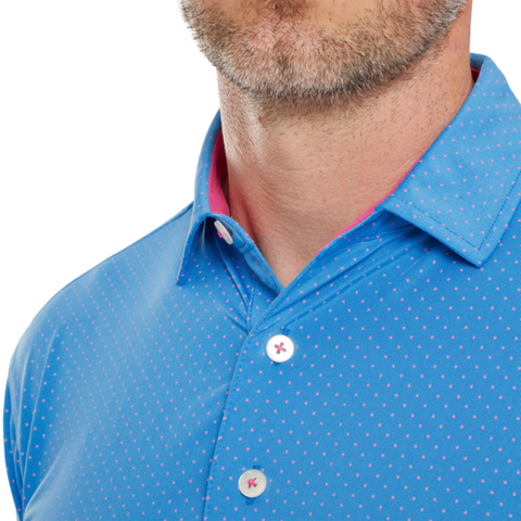 Close-up of a mans lower face and upper chest, wearing a FootJoy Lisle Dot Print Men’s Polo in blue with white polka dots and pink collar accents; moisture-wicking fabric keeps him cool and comfortable.