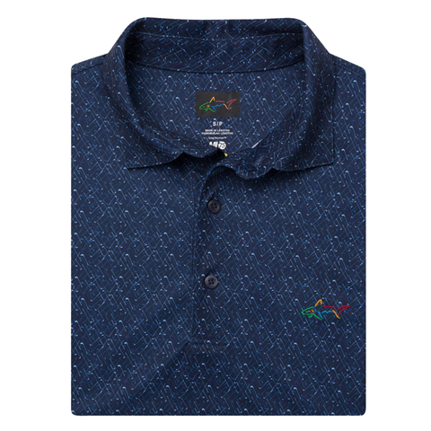 The Greg Norman Men's ML75 Club House Print Polo in navy features a subtle geometric pattern, three-button placket, moisture-wicking ML75 recycled fabric, and an embroidered multicolored shark logo on the chest.