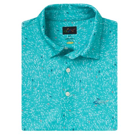 The Greg Norman Men’s ML75 Shark Frenzy Print Polo in Aquamarine is a short-sleeved, moisture-wicking golf shirt with a subtle abstract white and pink line pattern, white buttons, and an embroidered marlin logo on the chest.