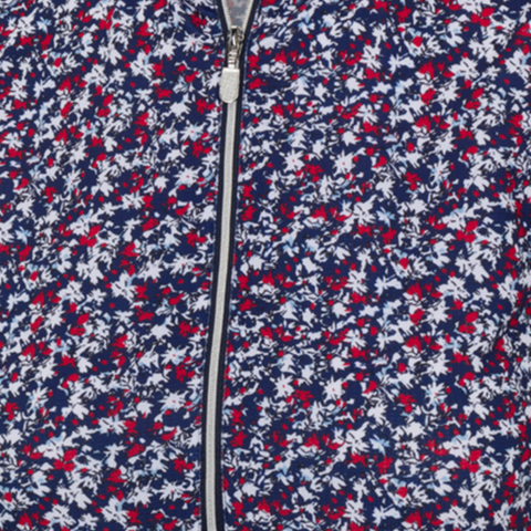 Close-up of a zippered fabric from the Greg Norman Women’s Play Dry Prestige Camo Floral Polo in Navy/Red, featuring a dense camo floral pattern and center zipper detail, inspired by women’s golf shirts.