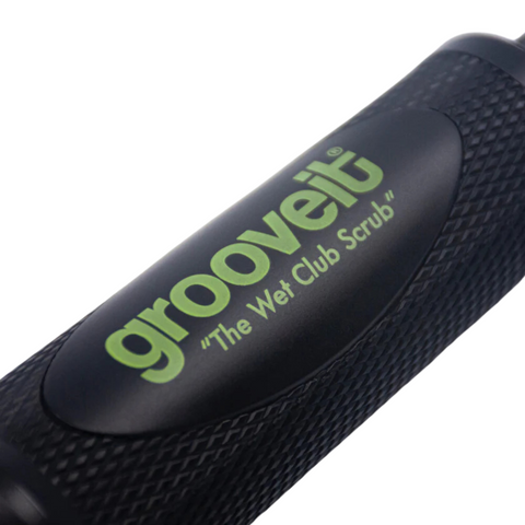 Close-up of the black Grooveit Wet Club Scrub Brush handle with a textured grip, showing the green Grooveit logo and “The Wet Club Scrub” slogan on an oval— a premium golf club cleaning tool for spotless clubs.