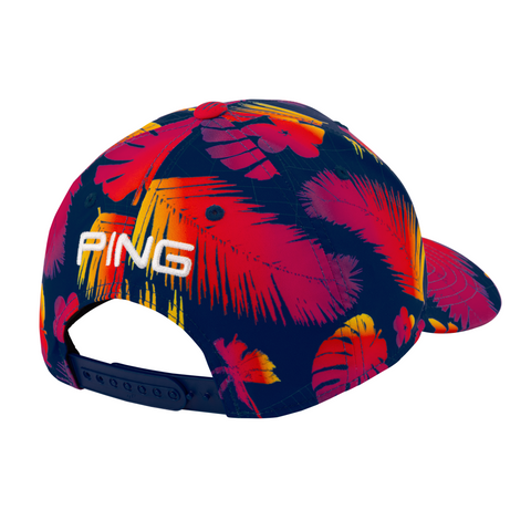 The PING 2025 Hawaii Collection Electric Sunset Tour Snapback by Ping is a navy blue limited-edition cap with a vibrant red, orange, and yellow tropical leaf design and PING embroidered in white above the adjustable back strap.