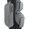 A PING Traverse golf bag in heather gray and black, featuring multiple zippered compartments and the PING logo printed on the bag
