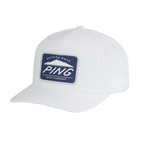 The PING Camelback Patch Cap by Ping is a white golf cap with a curved brim, featuring moisture-wicking fabric and a blue rectangular patch on the front that says Arizona Made PING Golf Company in white text.