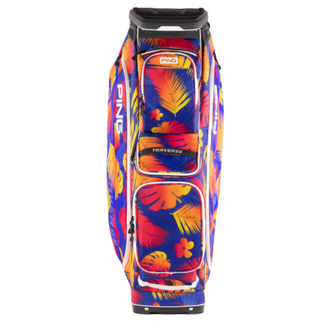 The Ping Traverse 244 Cart Bag features a vibrant tropical design with red, yellow, and orange leaves and flowers on a blue background. This lightweight bag includes a 14-way divider top and displays "TRAVERSE" on the front pocket.