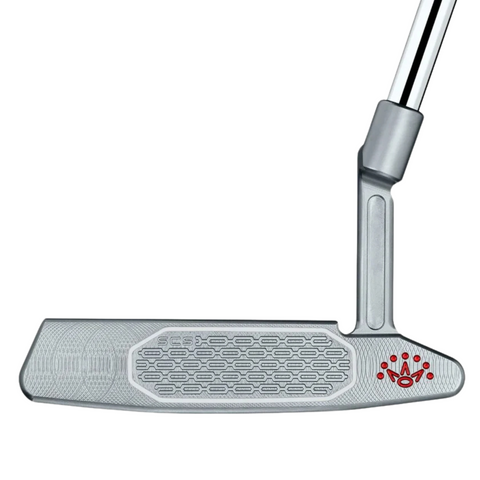 A close-up of the Scotty Cameron 2025 Studio Style Newport 2 Plus Putter head shows its precision milled, textured face with a red logo in the corner, attached to a chrome shaft.