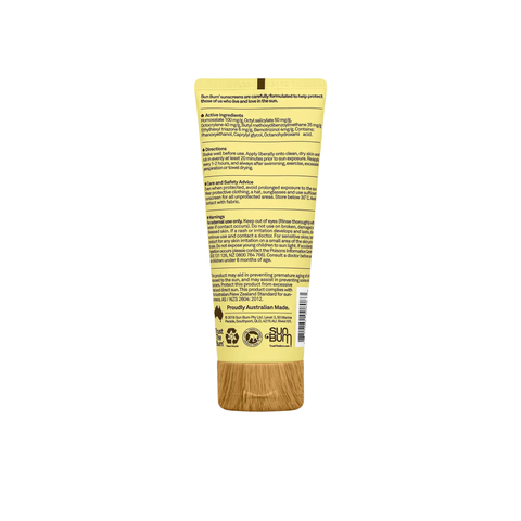 A yellow tube of Sun Bum Face SPF 50+ Lotion (88ml) displays active ingredients, directions, and warnings. The wood-textured cap sits below certification logos as the upright tube shows partial Sun Bum branding near the bottom.