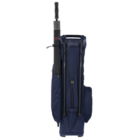 A Sun Mountain E-3.5 Carry Bag 2025 in navy blue stands upright against a white background, with a black umbrella in the side holder and featuring multiple pockets and straps.