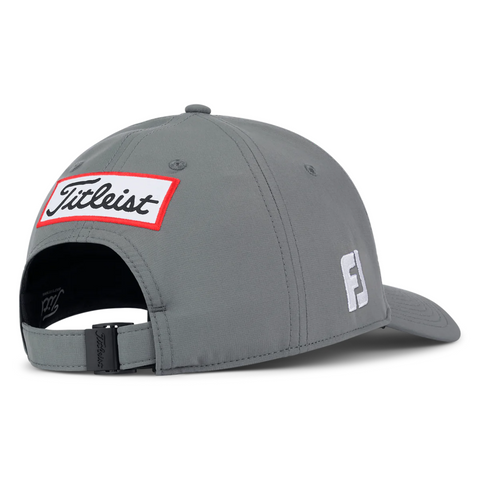 The Titleist 2025 Tour Performance Cap is a gray golf hat with a red and white Titleist back patch, a white F logo on the side, and an adjustable strap with black buckle—your perfect go-to cap for any round.