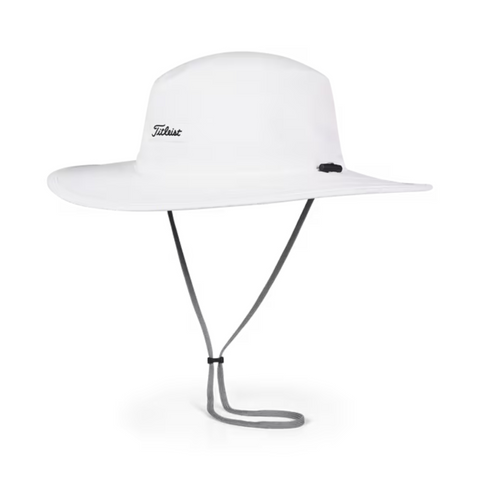 The Titleist Charleston Aussie Bucket Hat in White/Black features a wide brim, chin strap, and the Titleist logo on the front left for excellent sun protection. The hat is shown against a plain white background.
