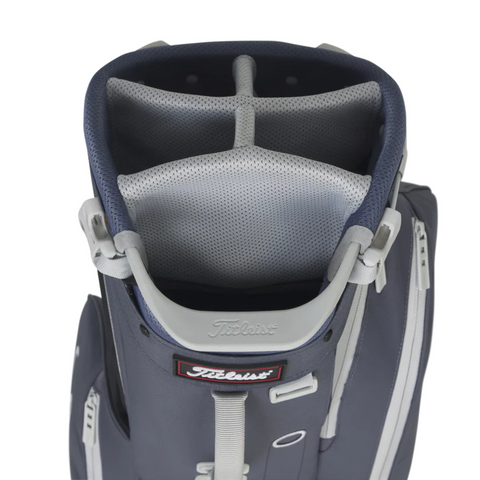 A close-up of the navy and gray Titleist Players 5 Stand Bag from Titleist shows four padded club dividers and zippered side pockets on this premium golf bag.