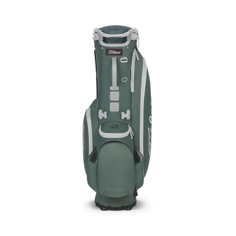 The Titleist Players 5 Stand Bag, shown standing upright in green and white, features multiple zippered pockets and a sturdy base—a premium golf bag from Titleist for golfers seeking quality and style.