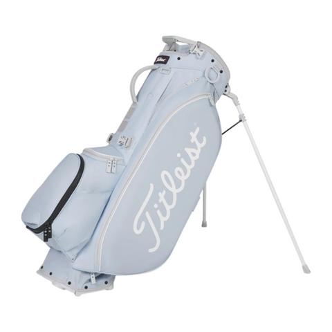The Titleist Players 5 Stand Bag in light blue features white detailing, a large Titleist logo, multiple zippered pockets, and sturdy white-legged stand—a premium choice for golfers.